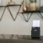 a black and white business card holder on a desk