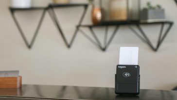 a black and white business card holder on a desk